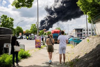 Passanten beobachten den Großbrand in Berlin-Lichterfelde: