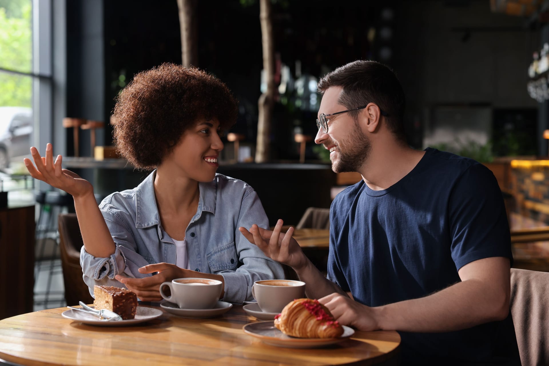 International dating. Lovely couple spending time together in cafe