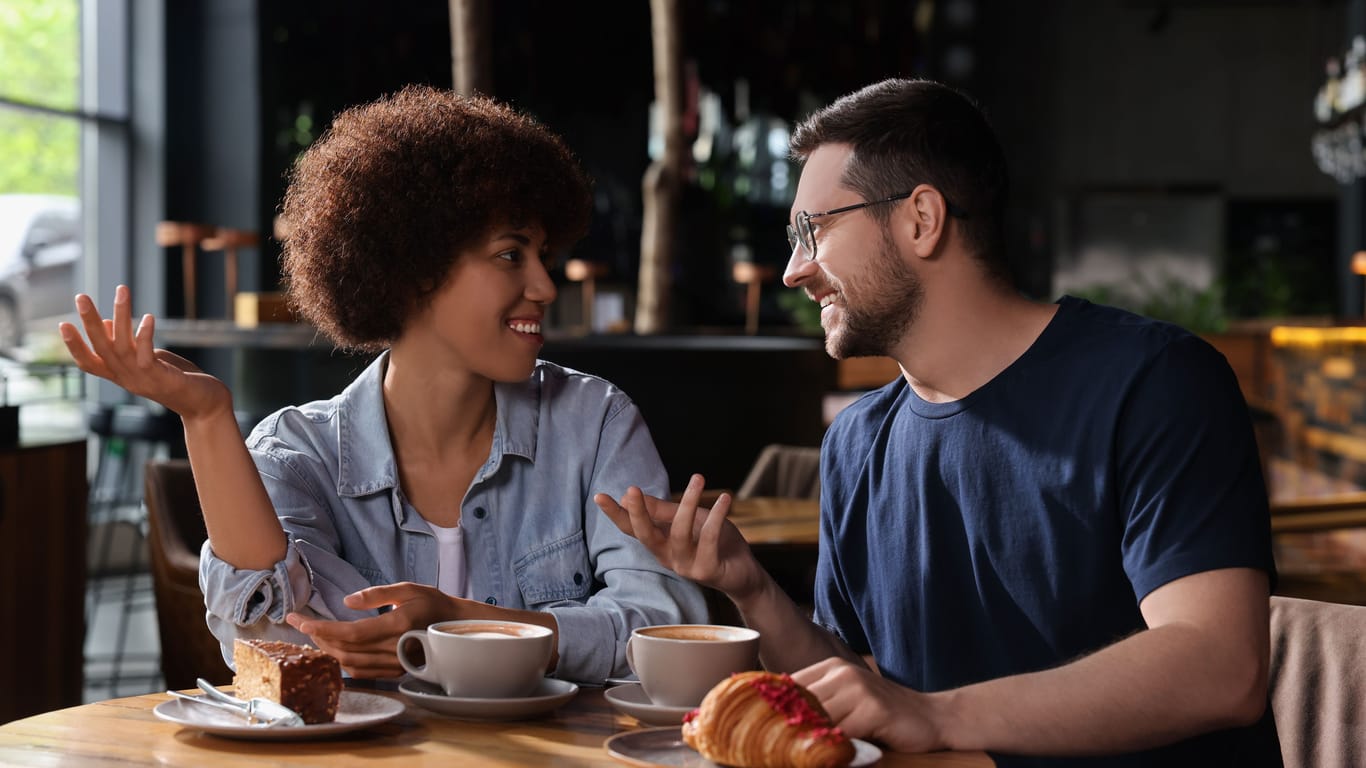 International dating. Lovely couple spending time together in cafe