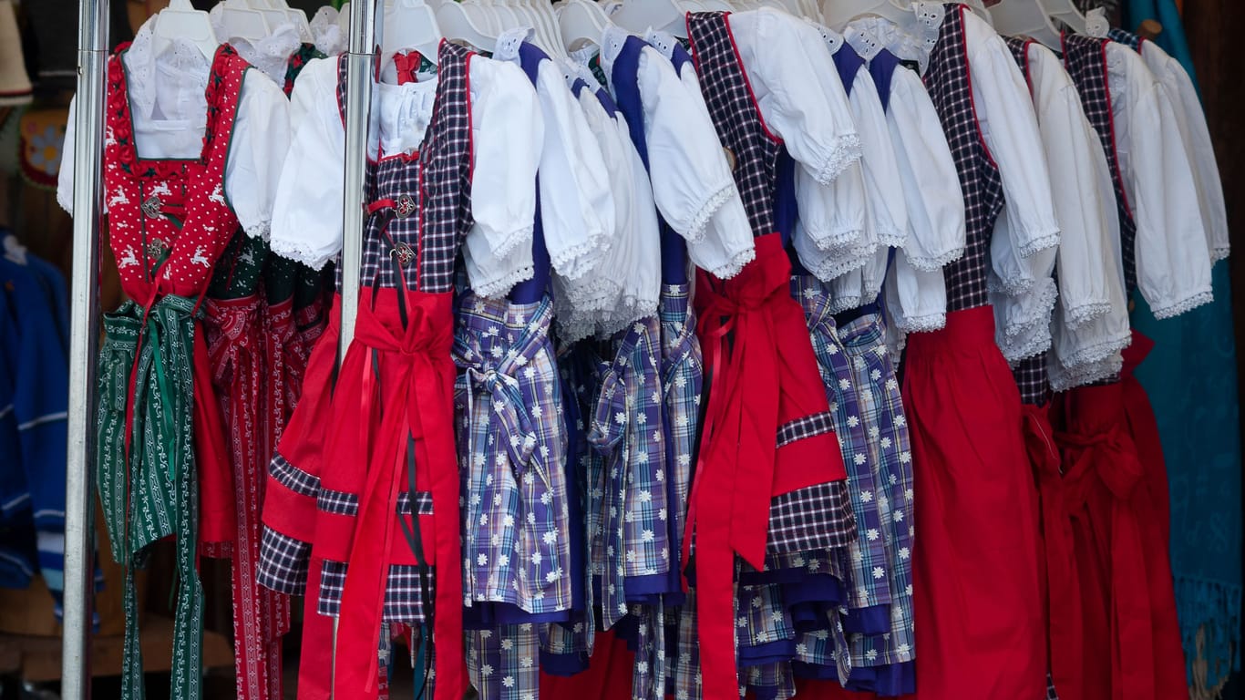 Traditional costumes in Bavaria: Dirndl, typical Alpine clothes for women, colorful selection in stores when shopping,