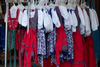 Traditional costumes in Bavaria: Dirndl, typical Alpine clothes for women, colorful selection in stores when shopping,