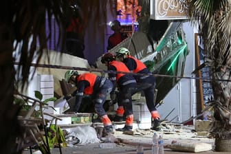 Rettungskräfte durchsuchen die Trümmer eines eingestürzten Gebäudes in Mallorca.