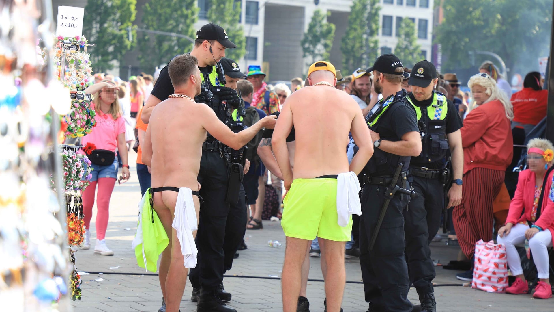 Zwei der drei Männer werden von der Polizei kontrolliert: Sie waren zunächst lediglich mit einer Bauchtasche bekleidet. Zwei der drei Männer werden von der Polizei kontrolliert: Sie waren zunächst lediglich mit einer Bauchtasche bekleidet.