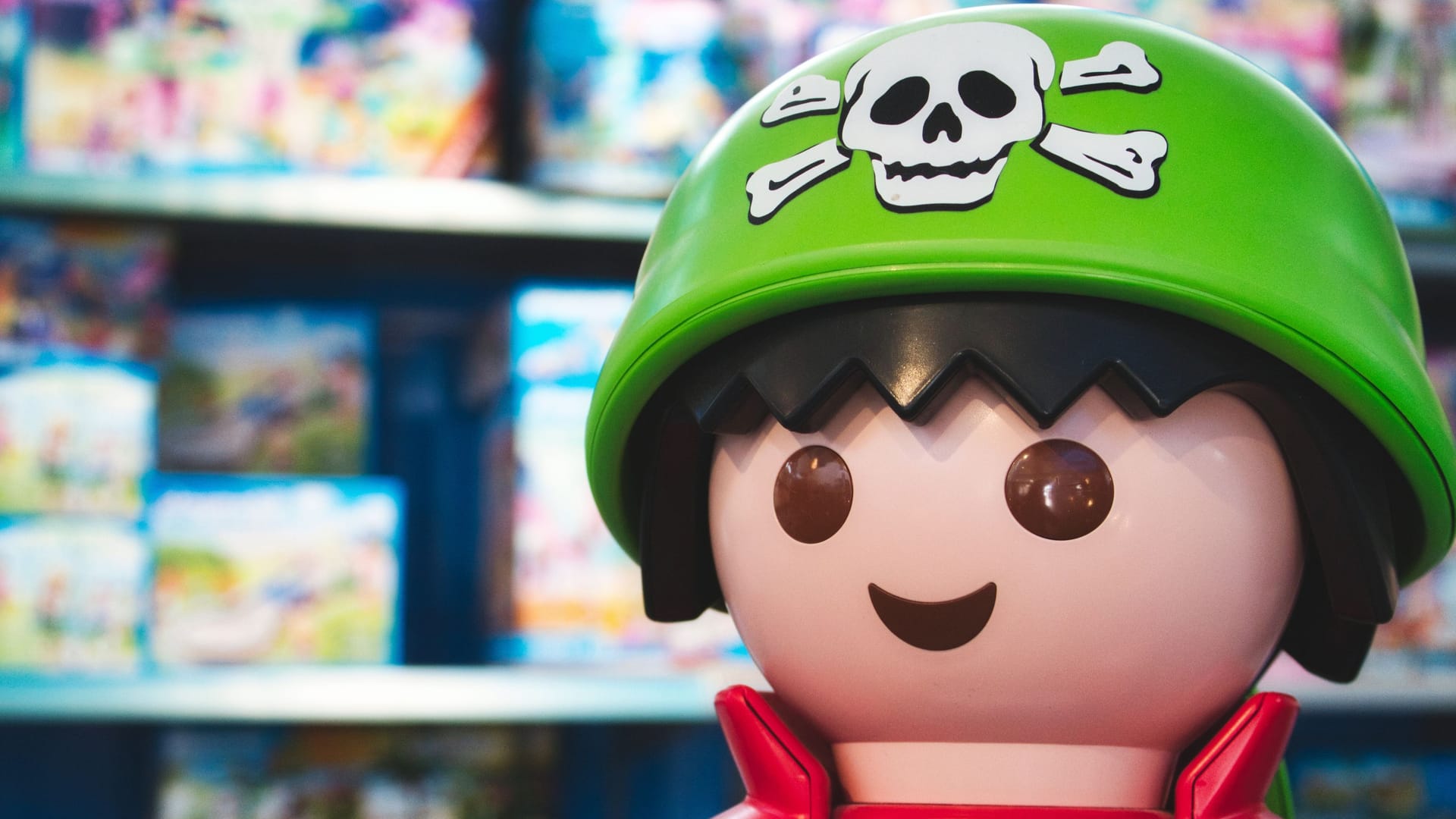 Giant Playmobil pirate figure in a toy shop with shelves of Playmobil box sets