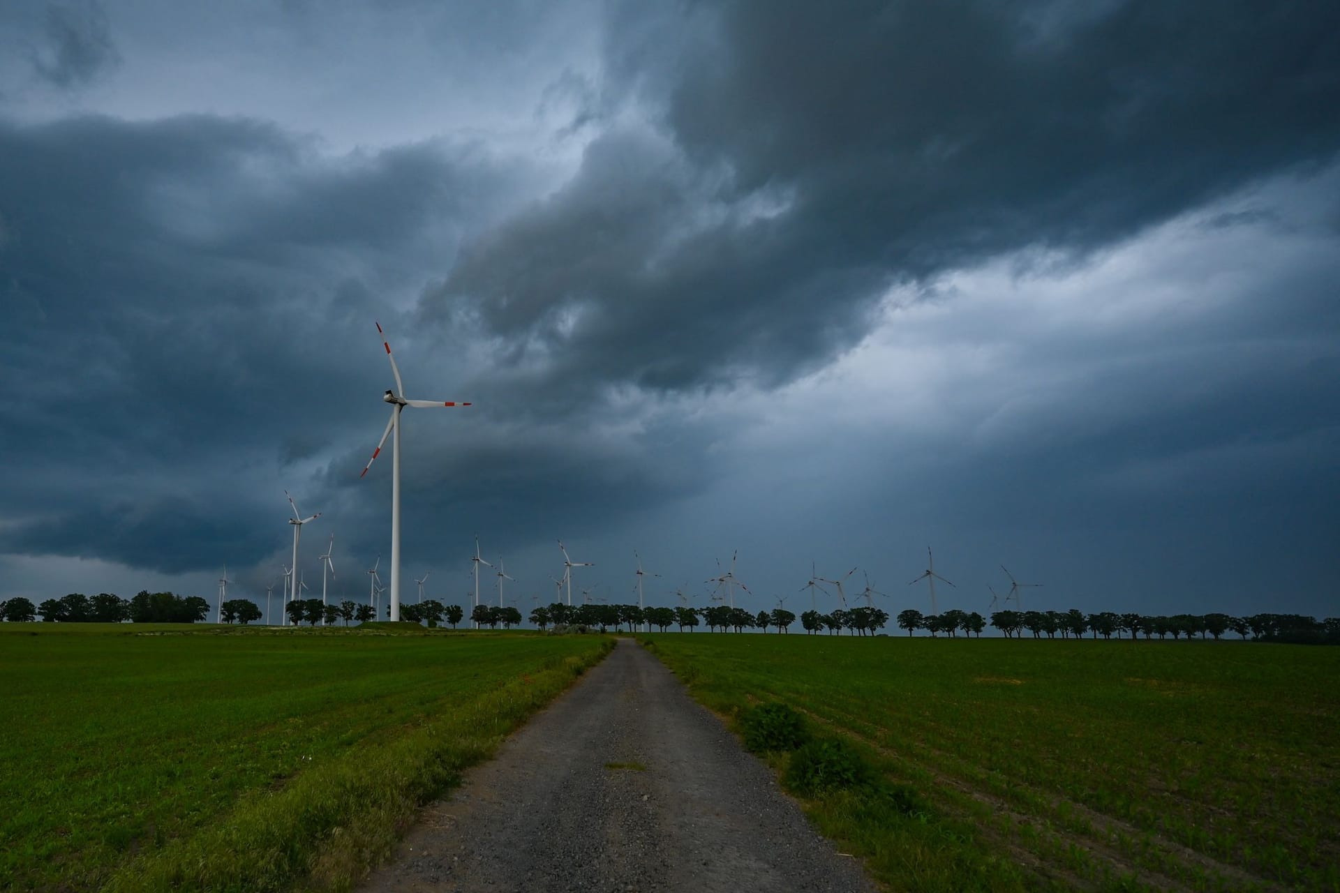 Dunkle Gewitterwolken ziehen am späten Abend über die Landschaft im Osten von Brandenburg.