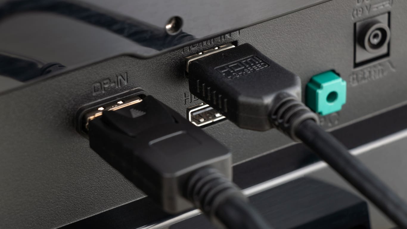 Close up of DisplayPort cable and HDMI cable connected to device