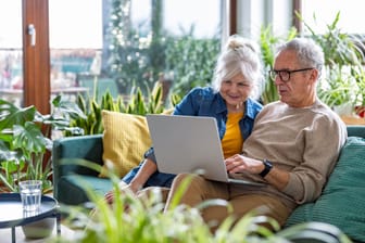 Rentnerpaar am Laptop: Derzeit zahlt die Rentenversicherung noch sechs verschiedene Altersrenten aus.