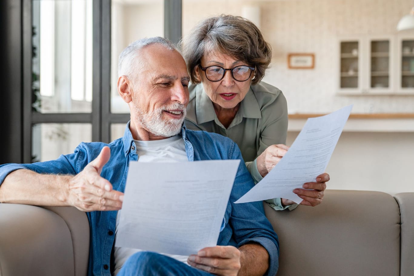 Rentnerpaar sichtet Unterlagen: Ab Juli steigen wieder die Altersbezüge.