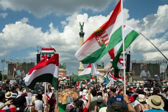 Menschen schwenken ungarische Nationalflaggen während einer Demonstration zur Europwahl.