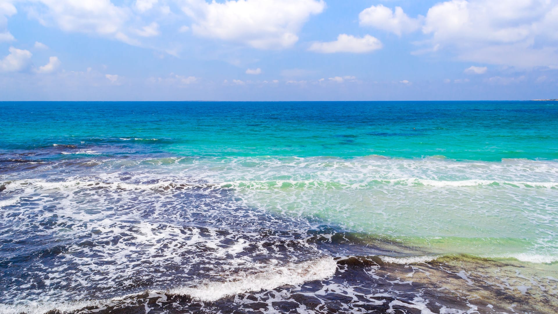 Turquoise water under a cloudy sky in Oristano