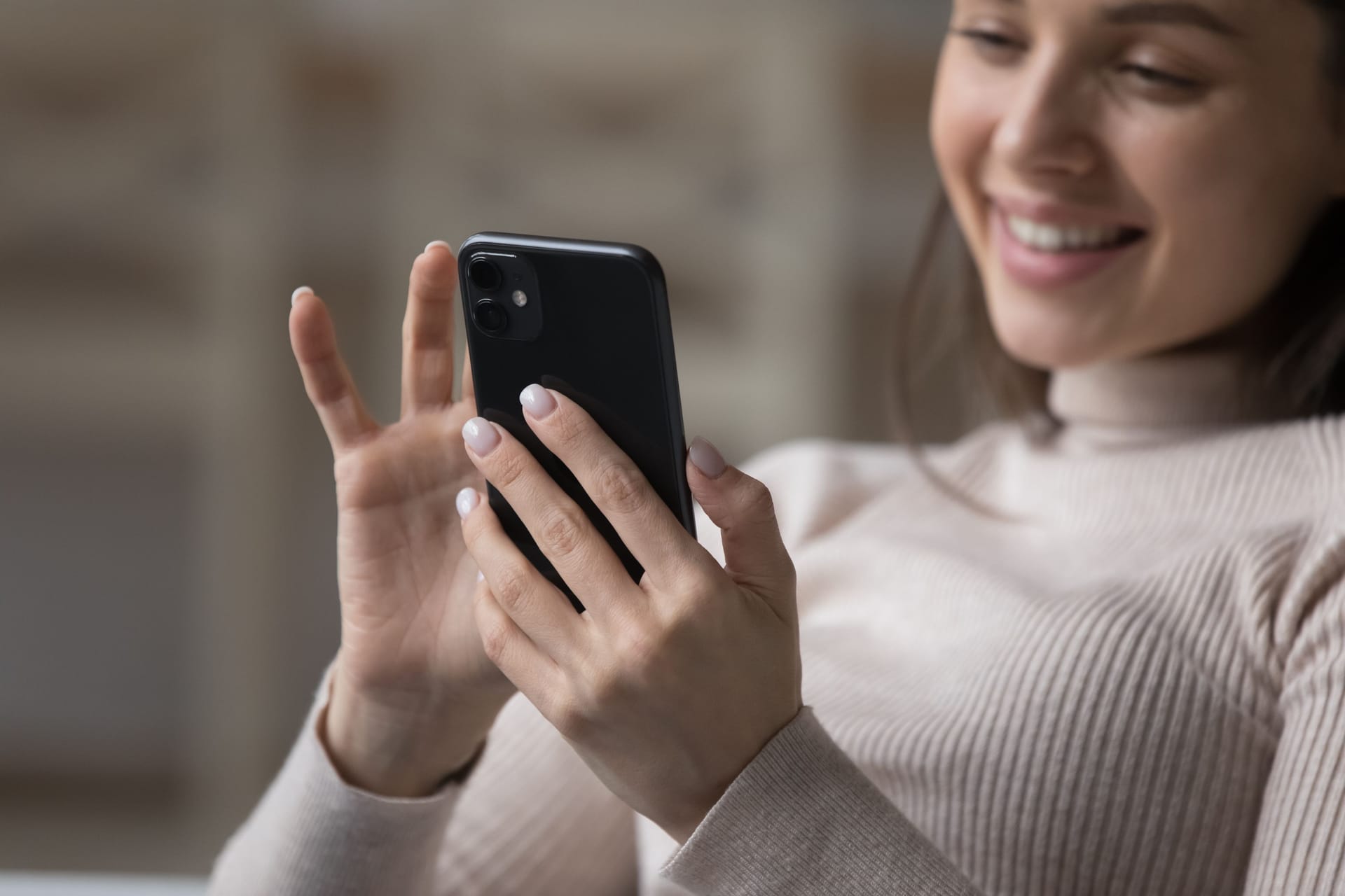 Close up cropped shot happy attractive woman using modern smartphone