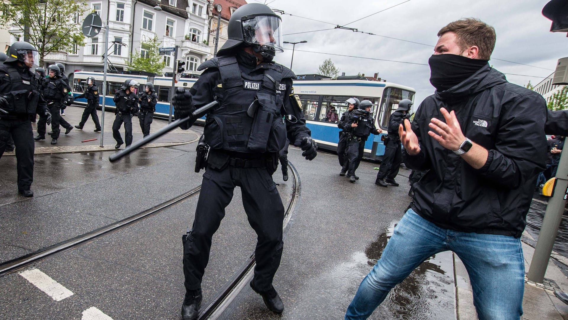 Ein Polizeibeamter bei einer körperlichen Auseinandersetzung mit dem Teilnehmer einer Demo in München (Archivbild).