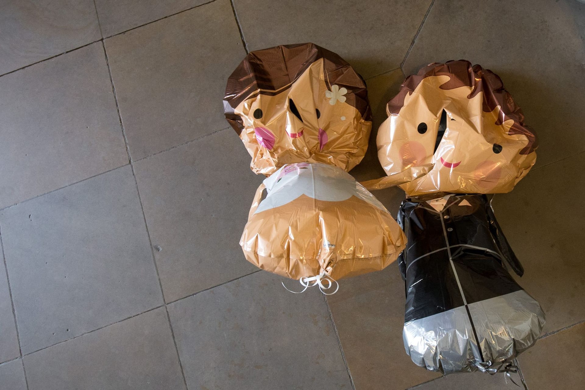 Luftballons in Form eines Brautpaars hängen an einer Decke Luftballons in Form eines Brautpaars hängen an einer Decke