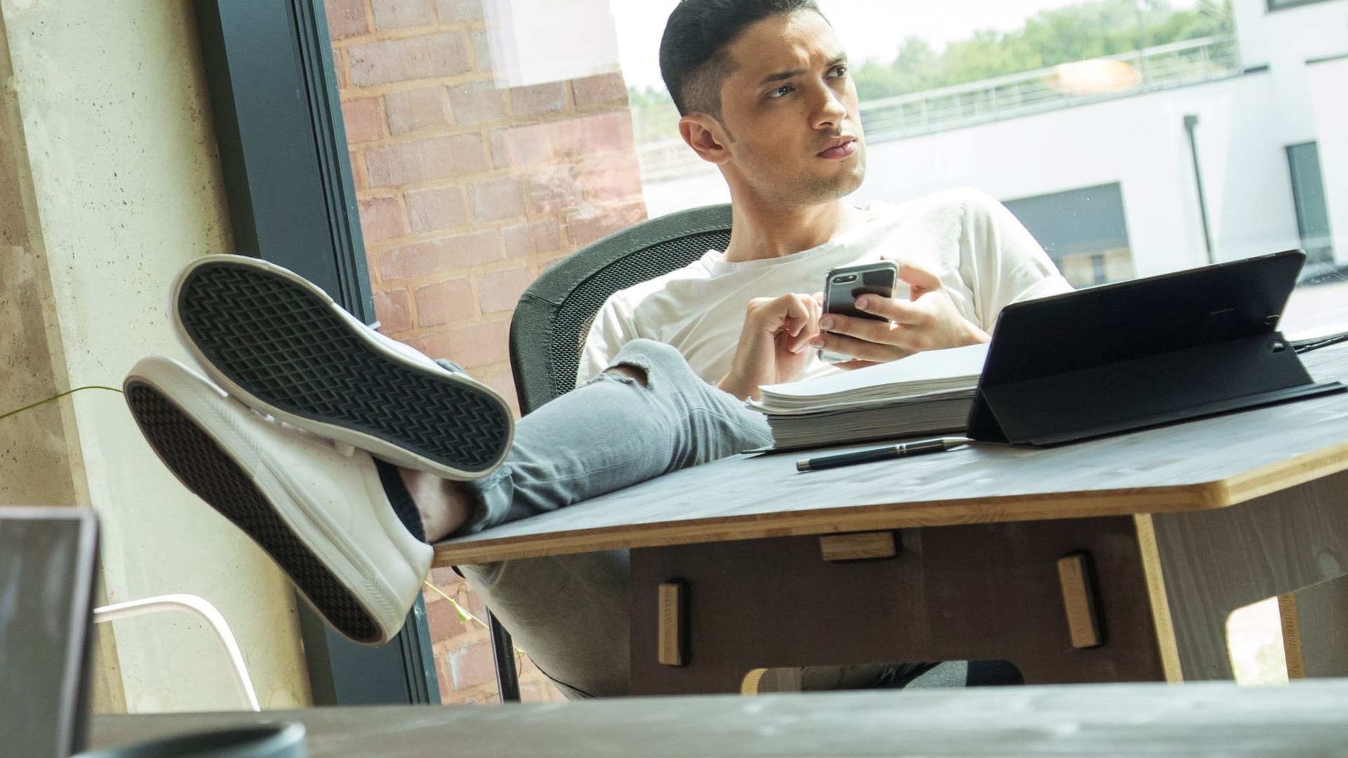 Mann sitzt am Schreibtisch Mann sitzt am Schreibtisch
