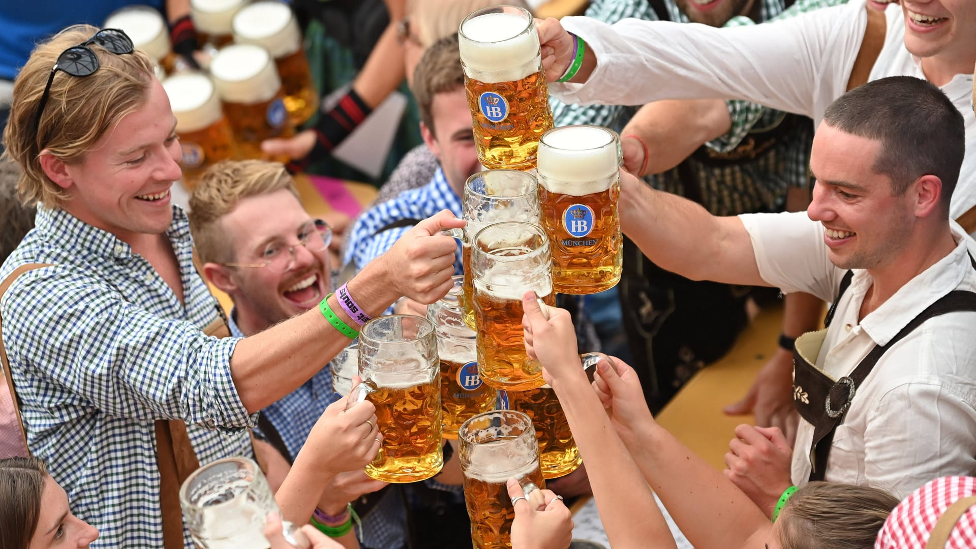 Menschen stoßen beim Oktoberfest mit Bier an (Archivbild): Ob der erneut gestiegene Maßpreis die Wiesnbesucher abschreckt, wird sich erst noch zeigen.