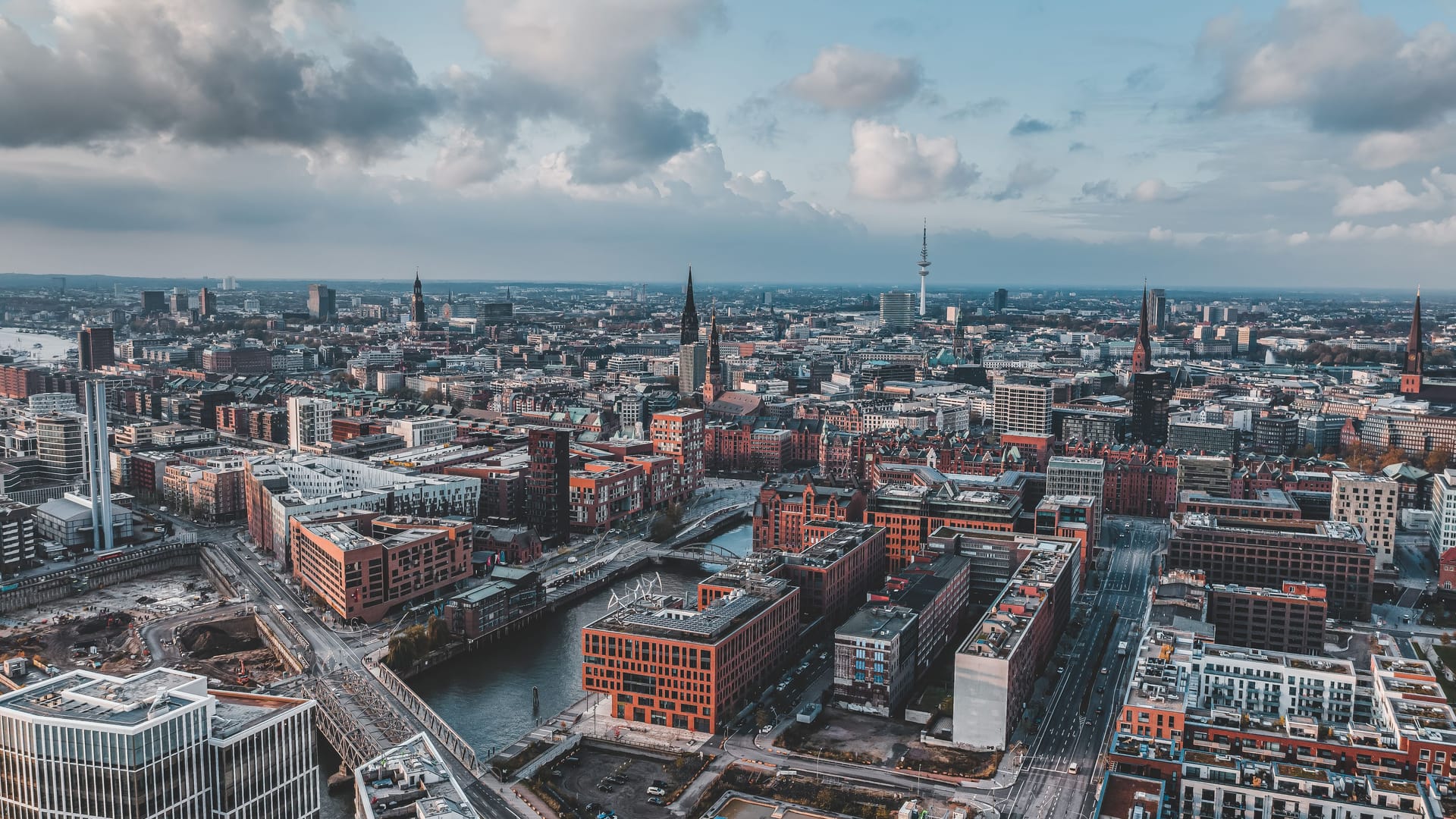 Aerial drone view of Port of Hamburg with clouds over historical city center and sea port