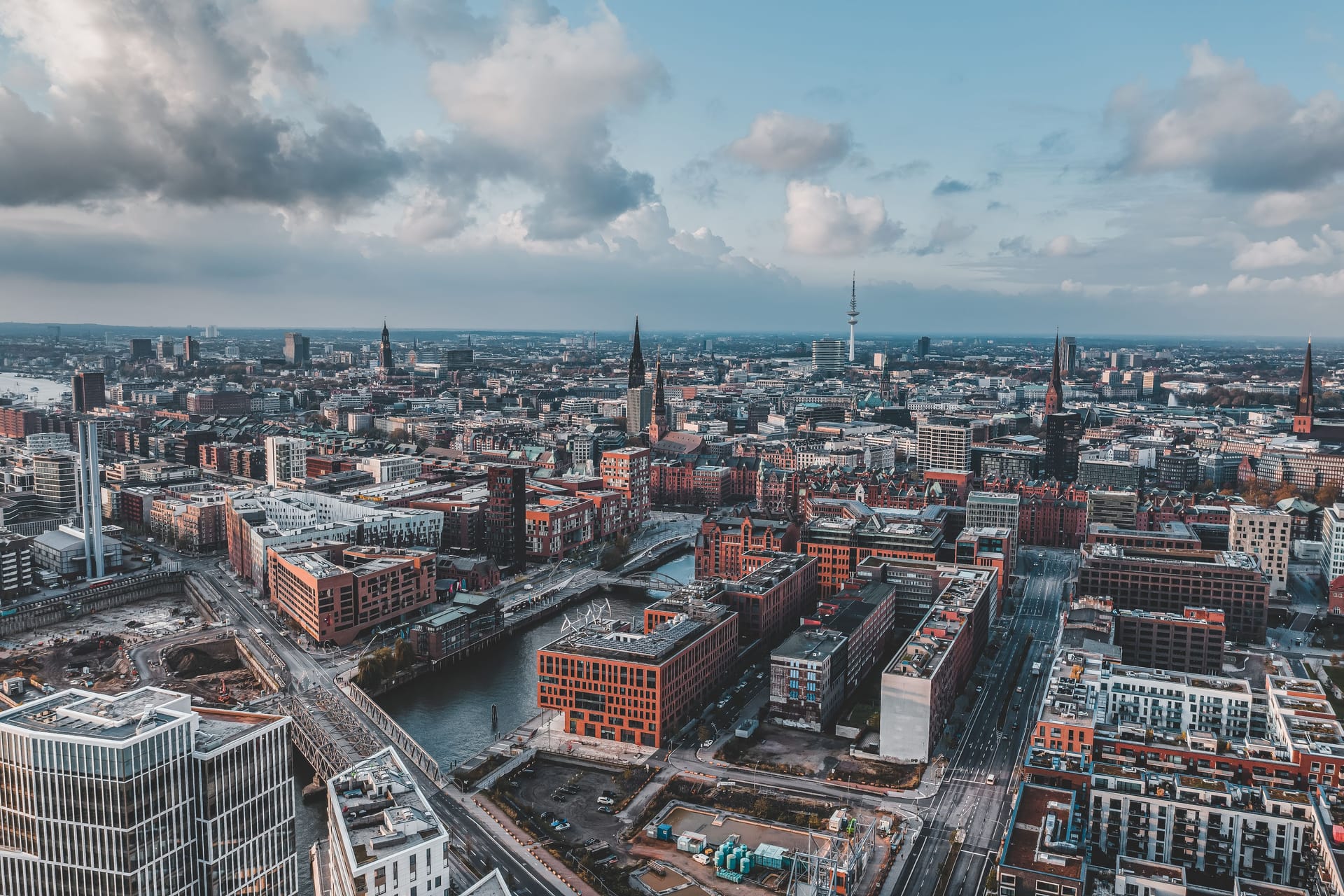 Aerial drone view of Port of Hamburg with clouds over historical city center and sea port