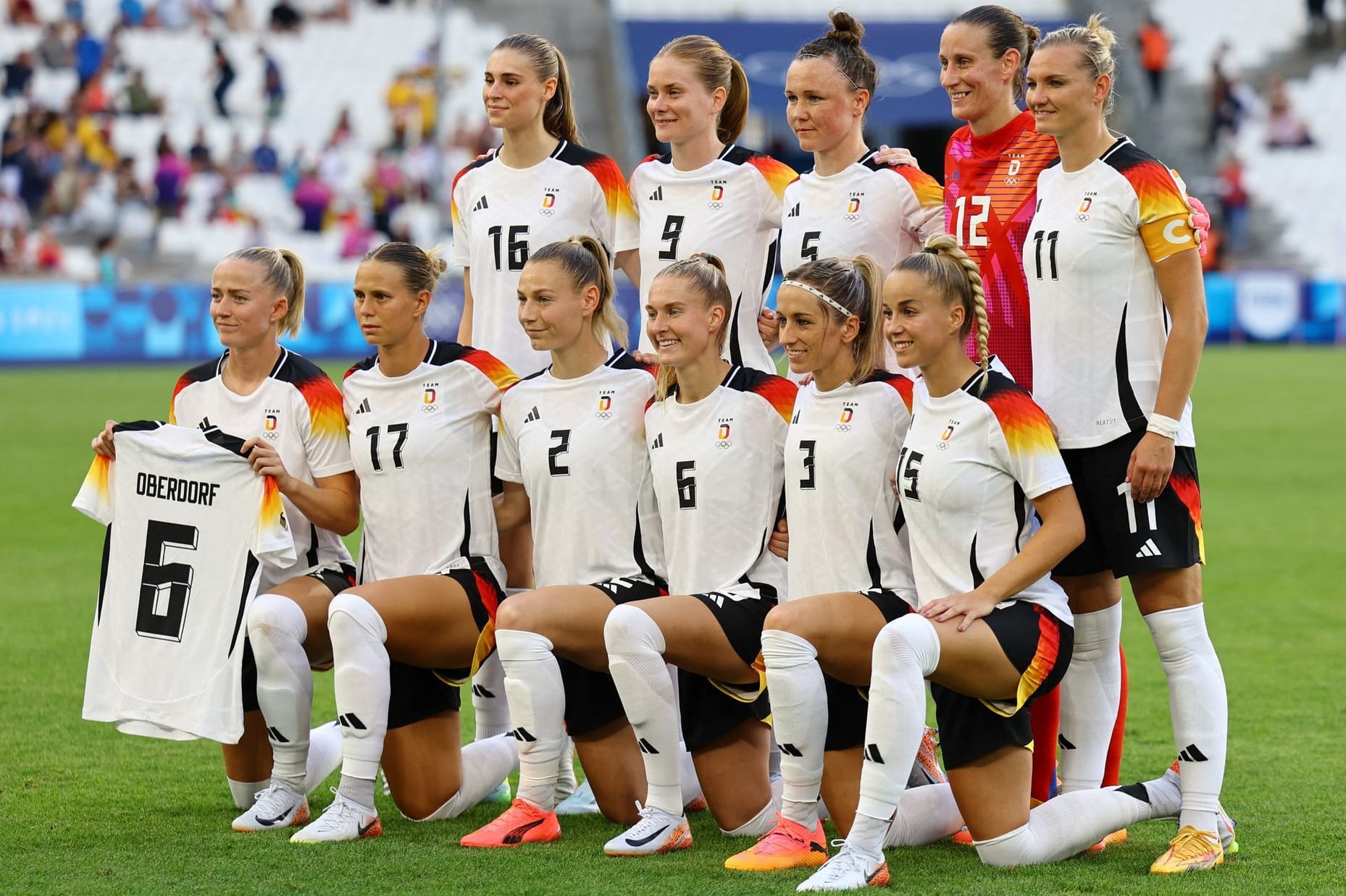 Gruß an die verletzte Teamkollegin: Lea Schüller (li.) hält das Trikot von Lena Oberdorf beim Mannschaftsfoto.