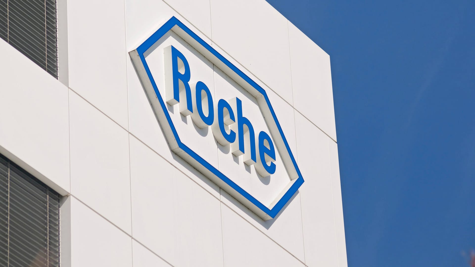 Roche sign in front at the Roche Diagnostics campus in Rotkreuz, Switzerland