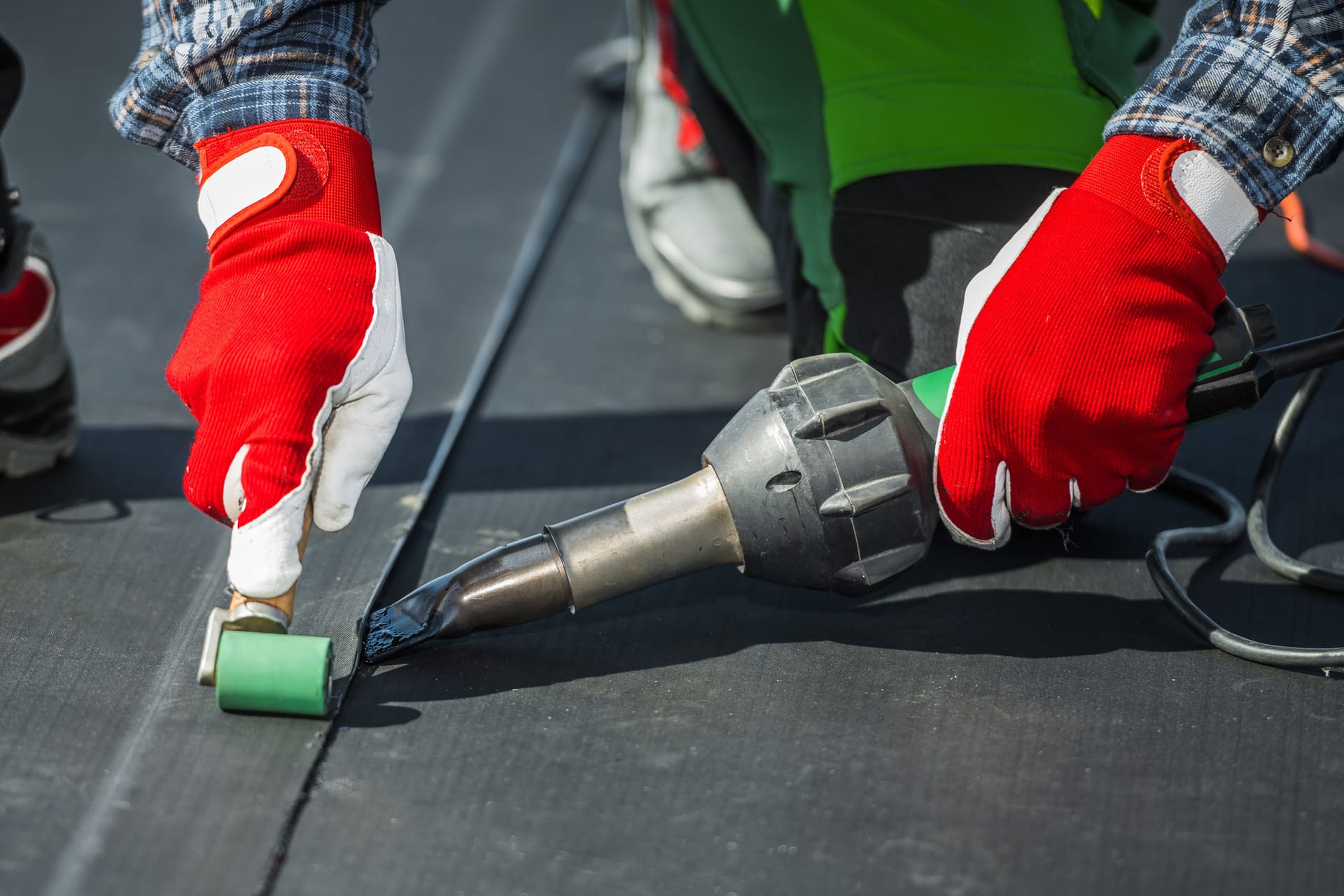 Contractor Covering Building Roof with EPDM Vinyl Rubber Material