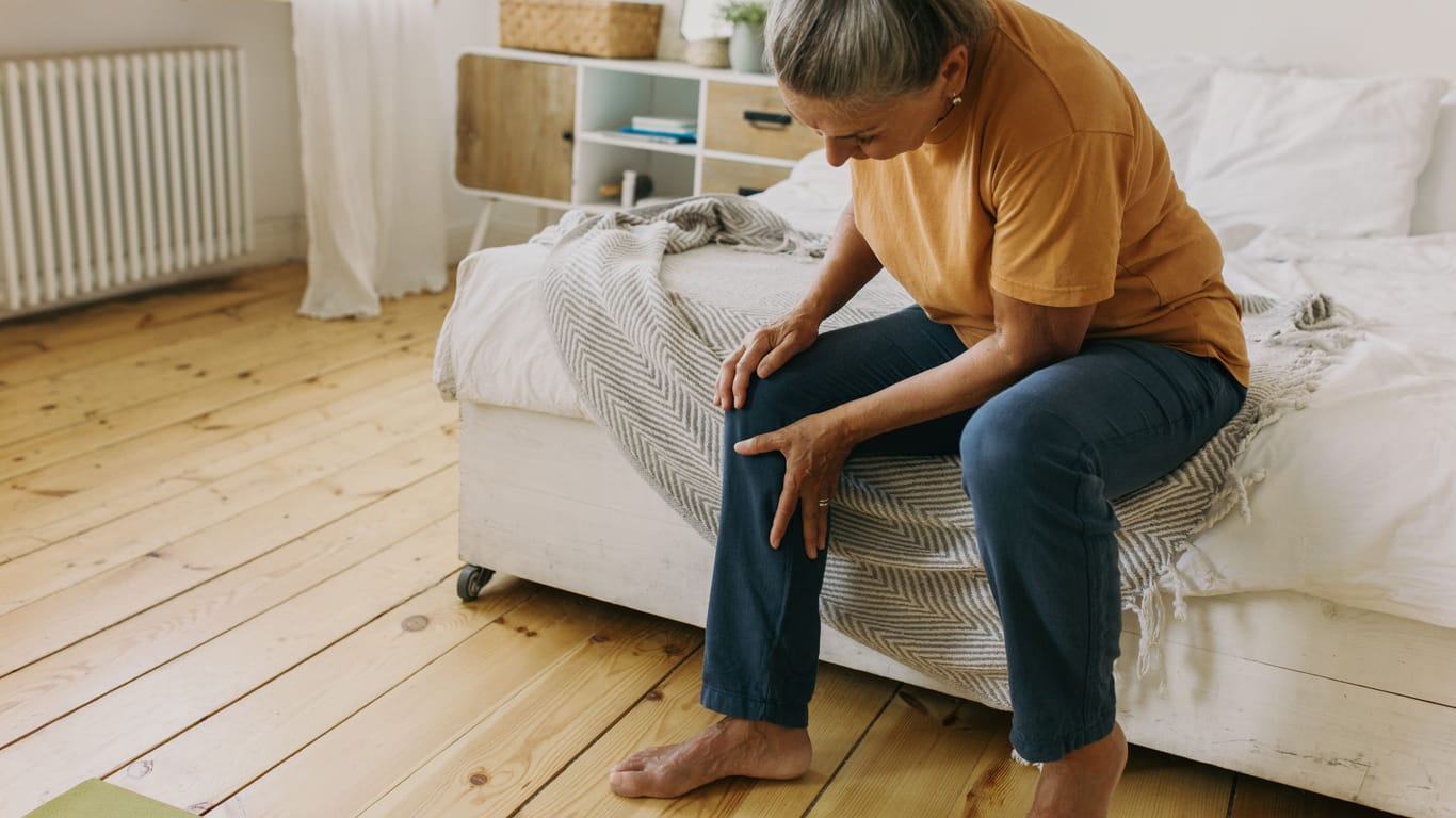 Frau mit Beinschmerzen: Krampfadern können sich auf unterschiedliche Weise bemerkbar machen.