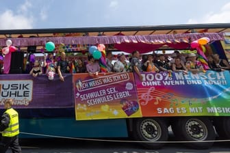 Menschen feiern bei der Parade zum Christopher Street Day in der Sächsischen Landeshauptstadt auf einem Wagen.