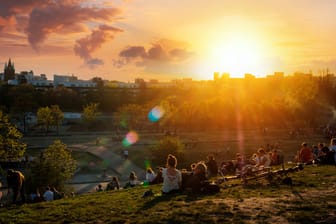 People enjoying view on sunset sky over skyline from public park (Mauerpark) on summer day in Berlin