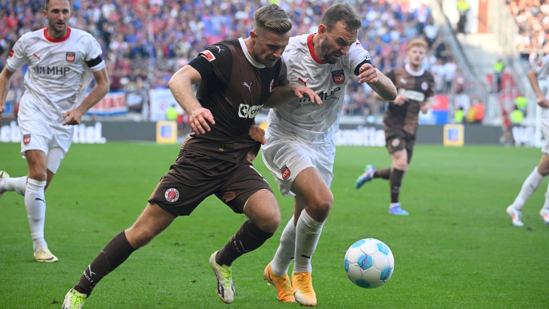 St. Paulis Johannes Eggestein (vorn, l-r) und Heidenheims Benedikt Gimber kämpfen um den Ball.