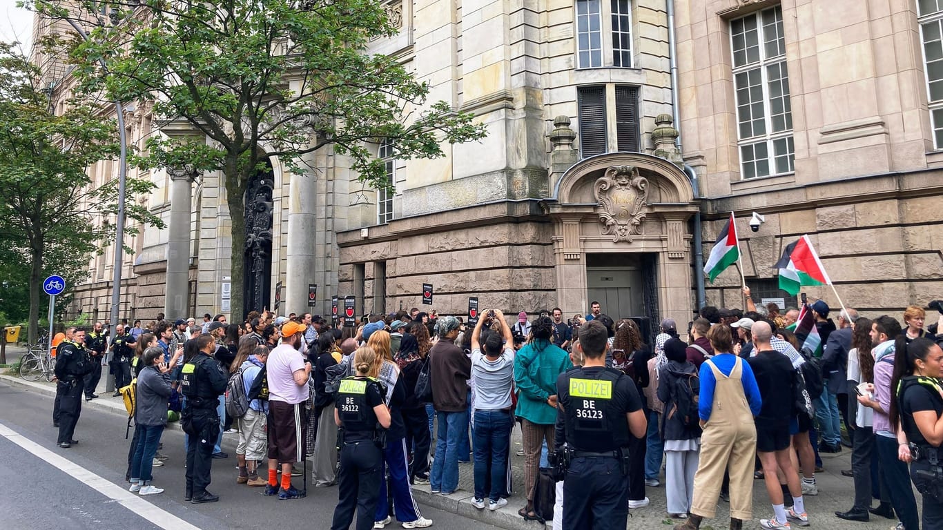 22.08.2024, Berlin: Demonstranten protestieren vor dem Kriminalgericht in Berlin-Moabit gegen den Prozess gegen eine 28-Jährige. Die Frau soll den Slogan «From the river to the sea, Palestine will be free» bei einer propalästinensischen Kundgebung skandiert haben. Foto: Marion van der Kraats/dpa