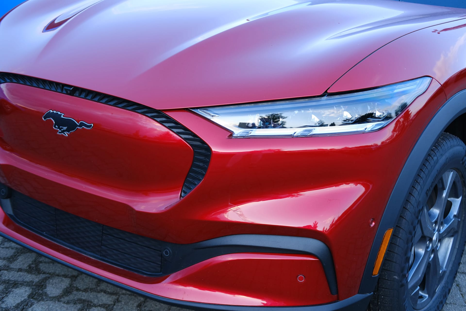 head lights of Electric Ford Mustang Mach-E on display in parking lot of company store specializing in sale of electric vehicles, alternative energy, Frankfurt - May 2023