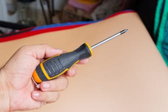 Man Holding Screwdriver - DIY Home Improvement