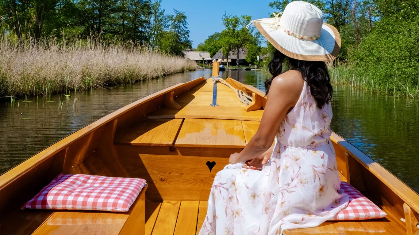 Giethoorn Netherlands Asian woman visit the village with wooden boat ,view of famous village