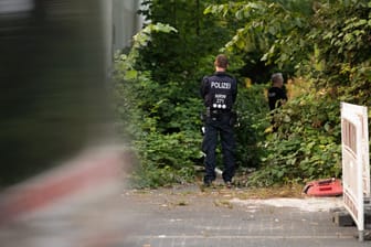 Ein Polizist beim Einsatz in Essen: In diesem Gebüsch hatten Jugendliche den Schädel eines toten Menschen entdeckt.