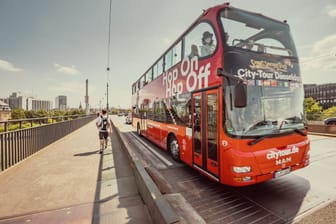 23 July 2022, Dusseldorf, Germany: The double-decker Hop on Hop off tourist bus transports travelers around the old city of Europe