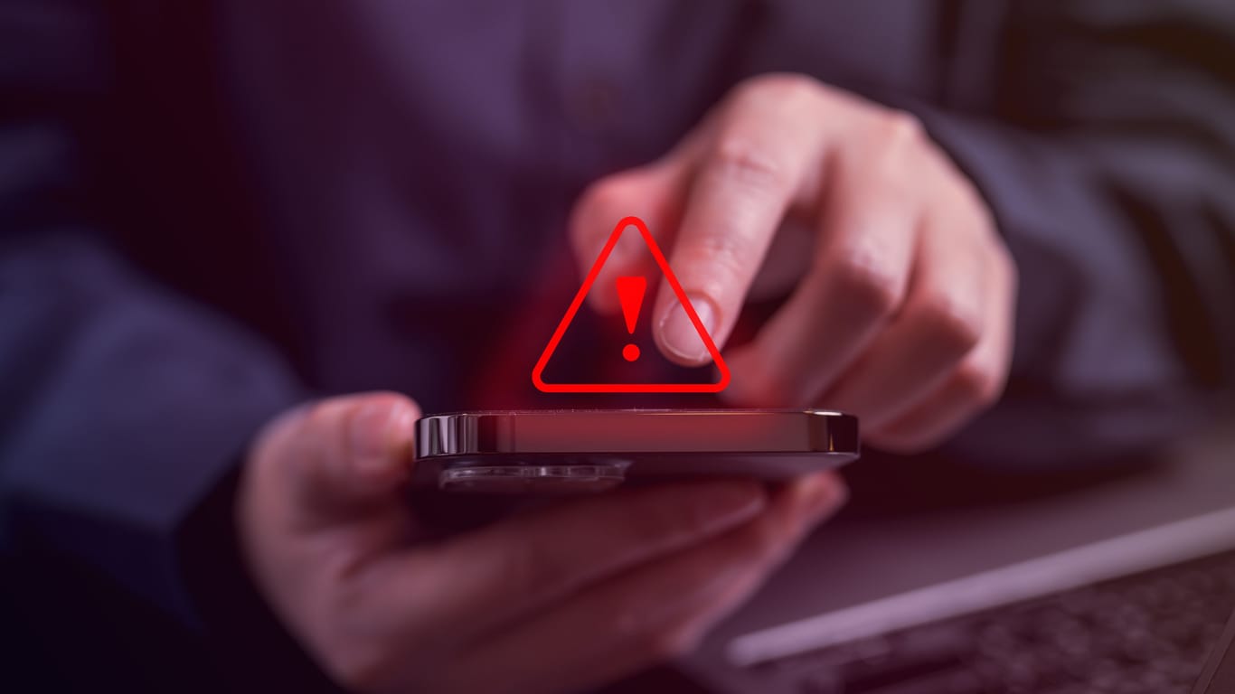 People with warning notification and spam message icon on mobile phone