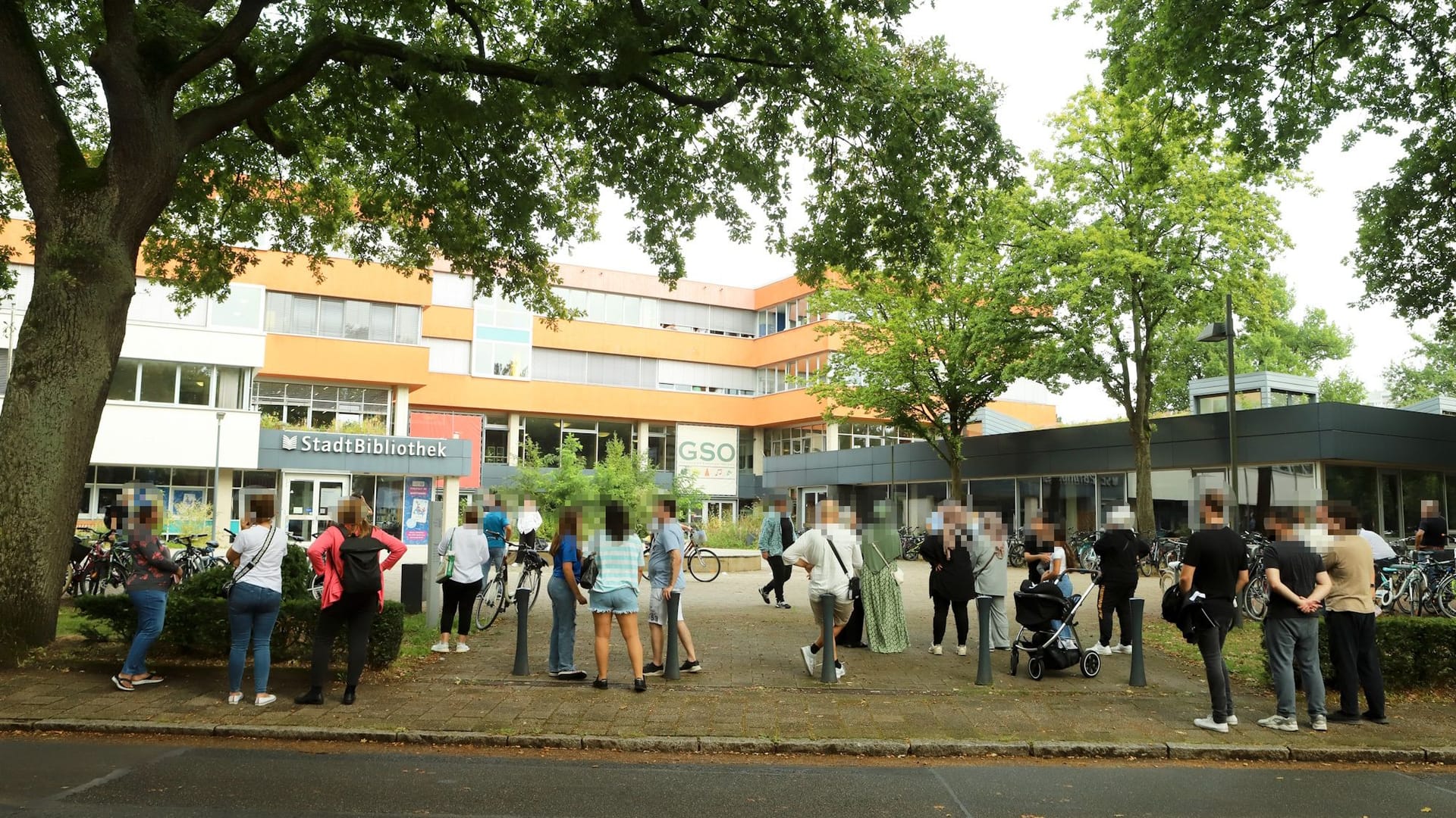 Viele besorgte Angehörige versammeln sich vor der Schule.