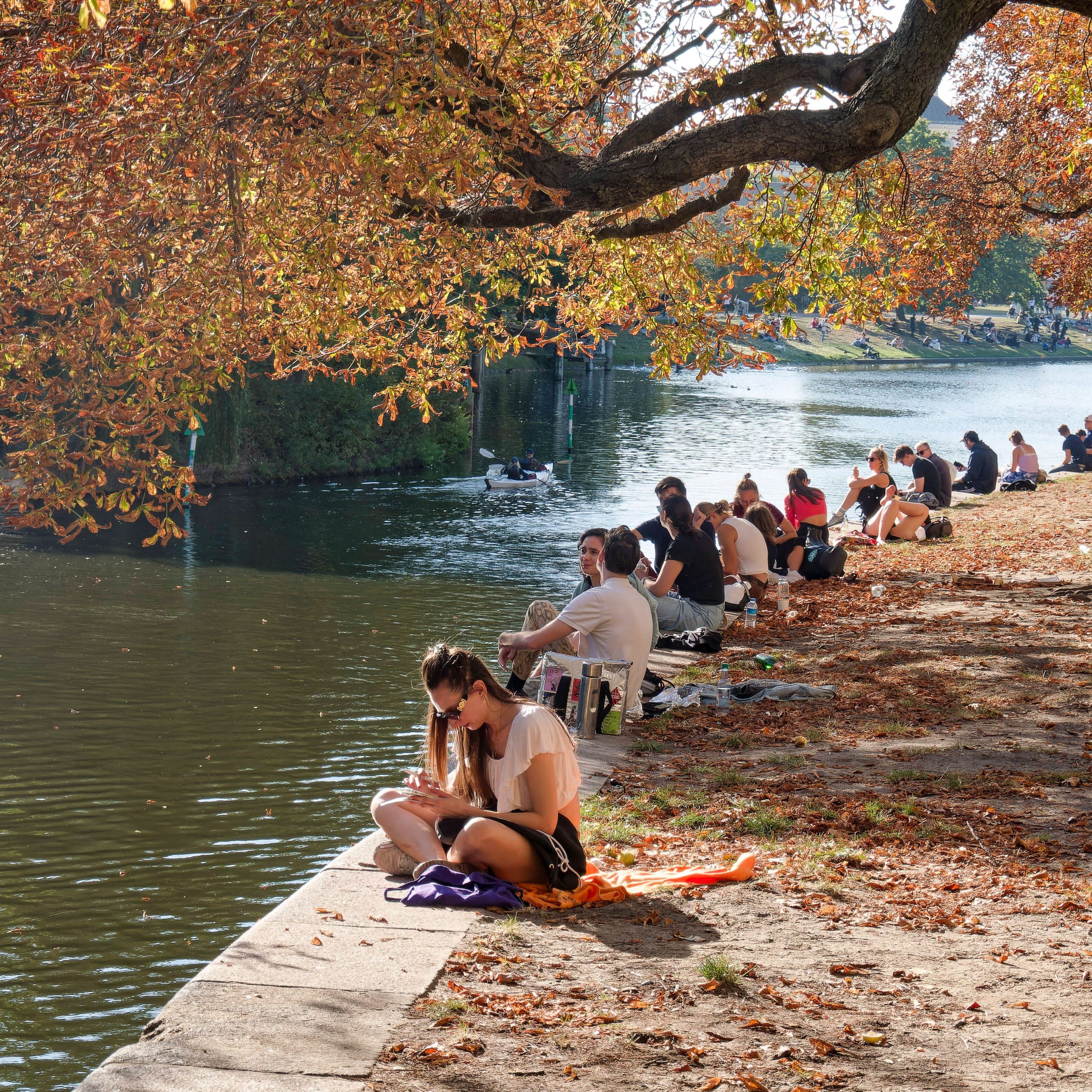 Junge Leute am Landwehrkanal in Berlin-Kreuzberg: Im Osten bleibt es auch am Samstag trocken.