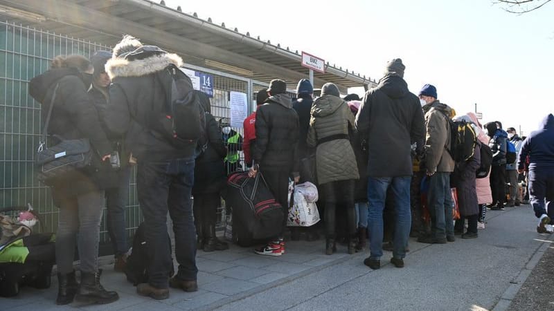 Geflüchtete warten vor einer Flüchtlingsunterkunft auf Einlass: Im Landkreis München sind die Behörden mit der Anzahl der Geflüchteten überfordert.