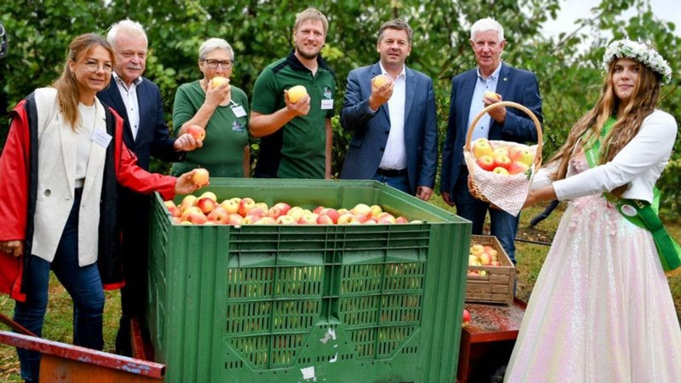 Start in die Apfelsaison 2024: Blütenkönigin Alida I., Sachsen-Anahlts Landwirtschaftsminister Sven Schulze und andere.