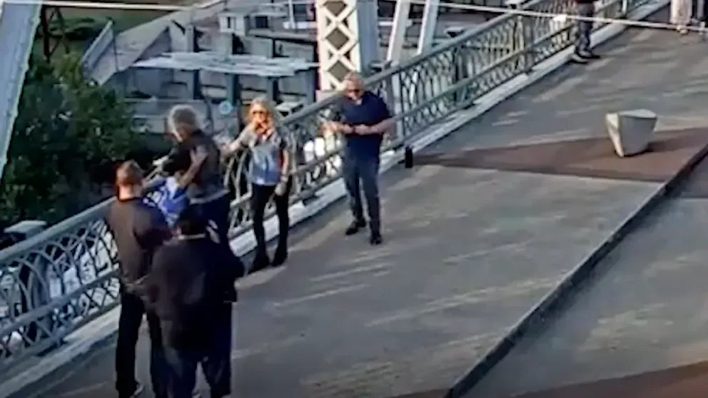 Jon Bon Jovi und die Frau umarmen sich auf der Brücke.