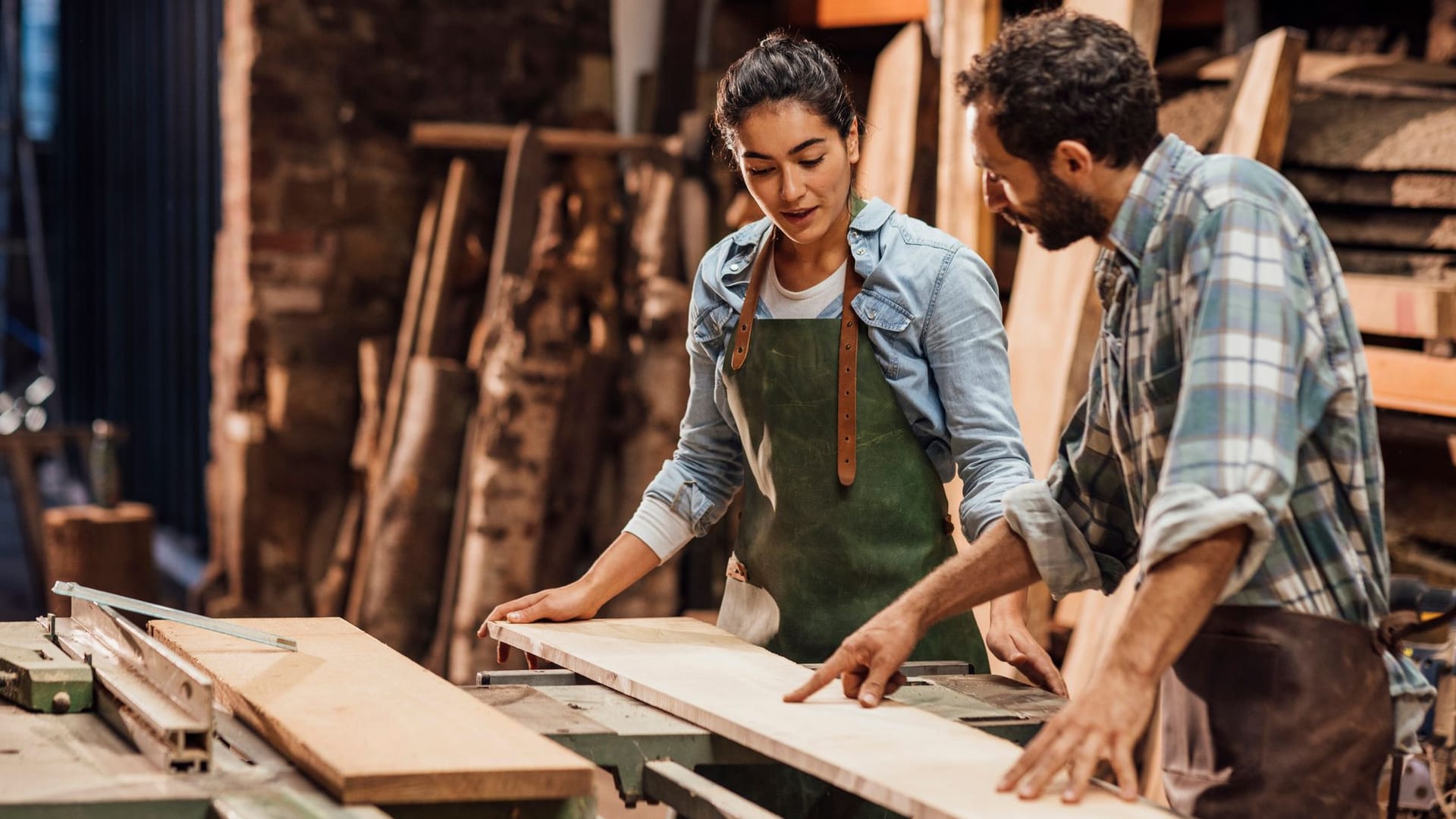 Schreiner:in arbeiten gemeinsam in einer Tischlerei