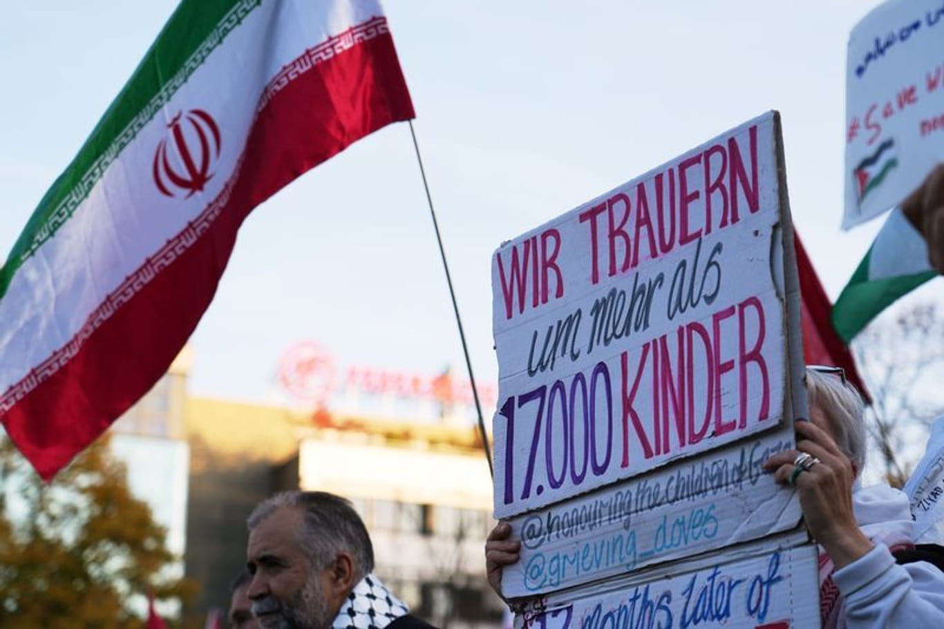 Teilnehmer einer Pro-Palästina Demonstration halten Plakate und iranische Flaggen hoch: Am Wittenbergplatz demonstrieren mehr als 300 Menschen für Solidarität mit Palästina.