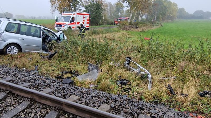 Die von der Freiwillige Feuerwehr Gemeinde Schiffdorf zur Verfügung gestellte Aufnahme zeigt Trümmerteile eines Zugs und Autos neben einer Bahnstrecke während Feuerwehr und Rettungsdienst im Einsatz sind. Für 52 Reisegäste in einem Zug Richtung Bremerhaven endete die Fahrt wegen eines Zusammenstoßes der Bahn mit einem Auto im Landkreis Cuxhaven.