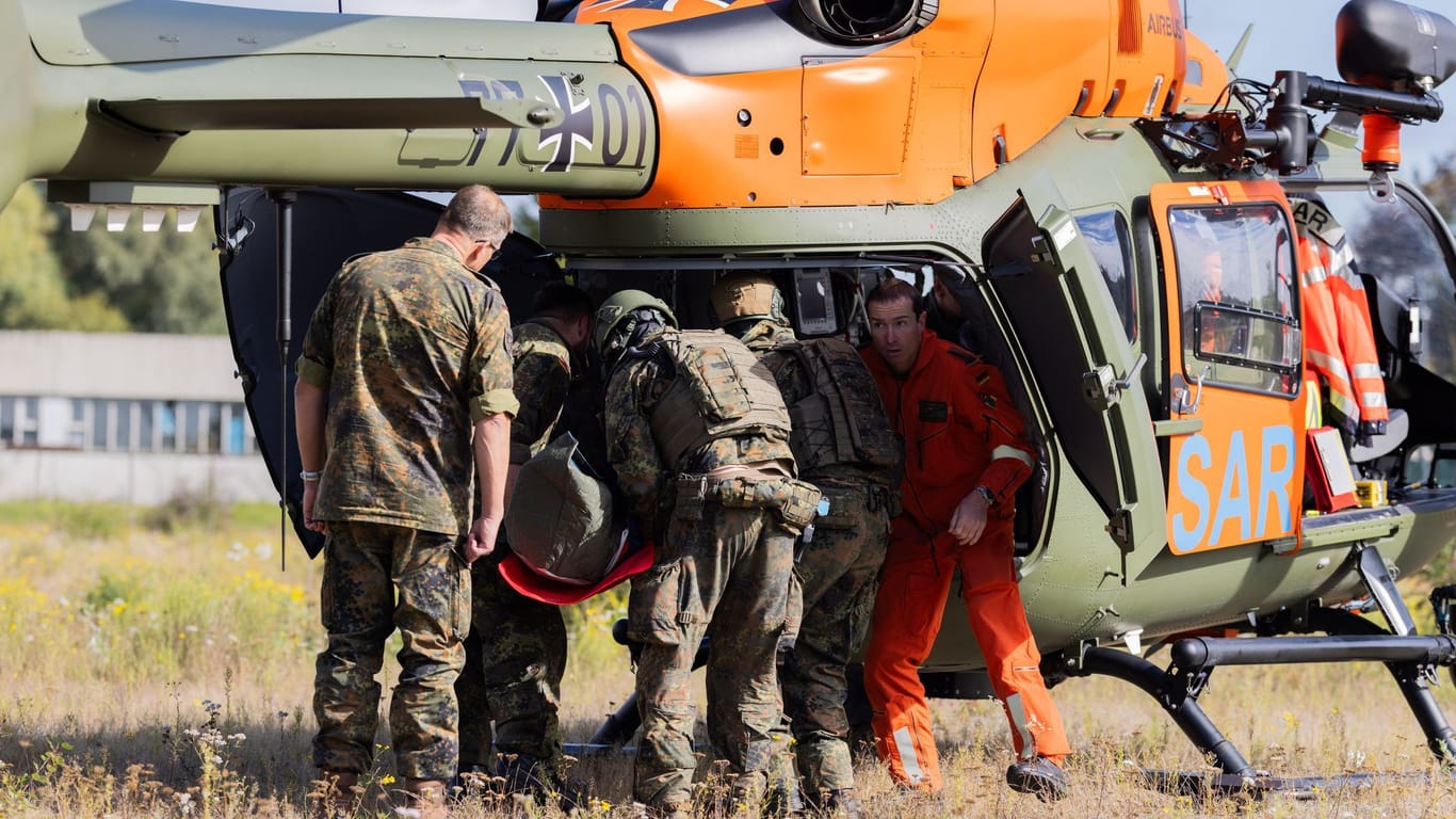 Bundeswehrsoldaten des Such- und Rettungsdienstes der Bundeswehr überführen einen fiktiven Verletzten zu einem Rettungshubschrauber. Bei der Übung gab es aber auch tatsächlich Verletzte.