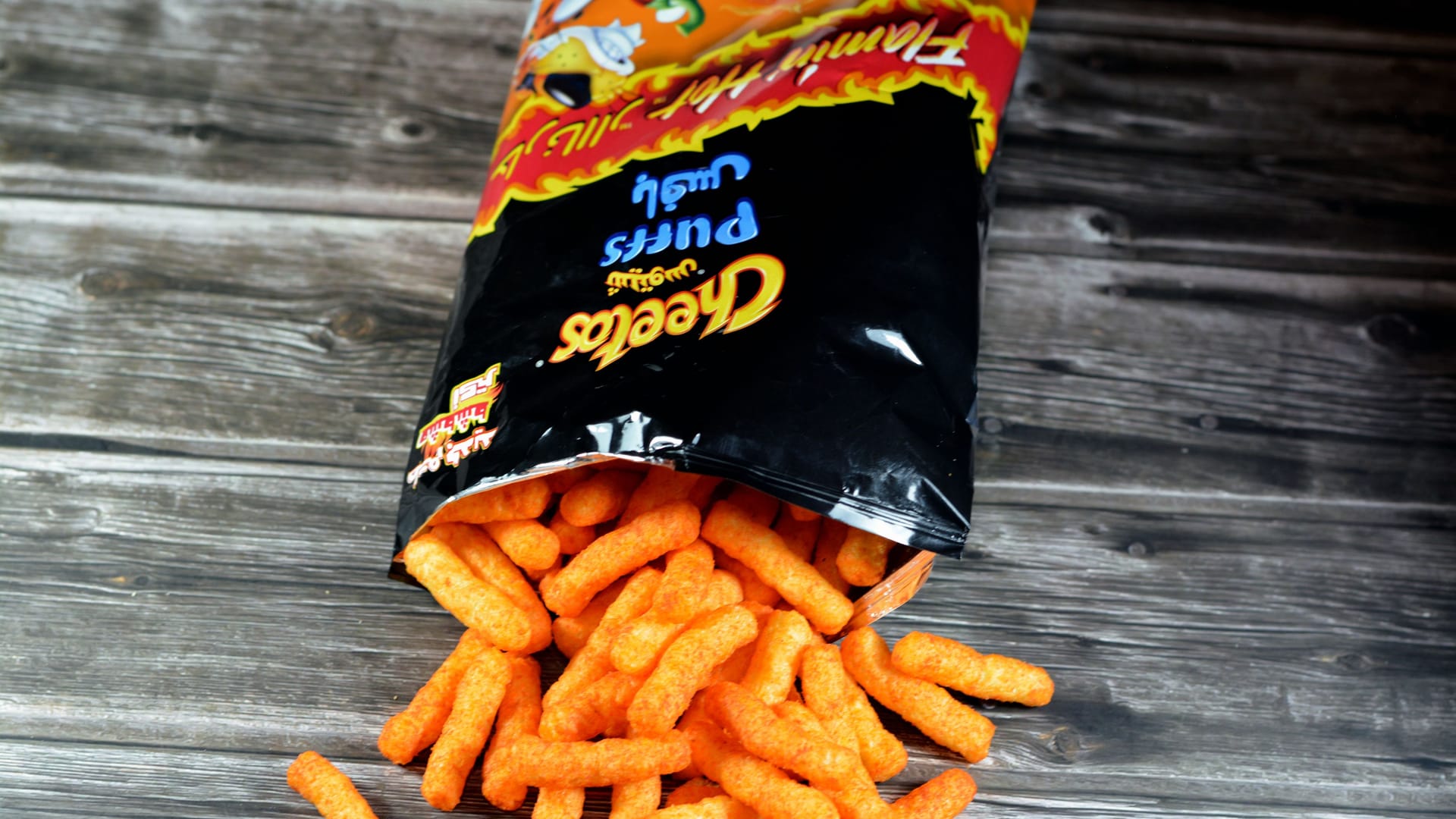Cairo, Egypt, February 10 2023: Cheetos puffs with enriched corn meal that contain flavors and milk ingredients with oil, protein, cheese, crunchy snack sticks flavored and salty, selective focus