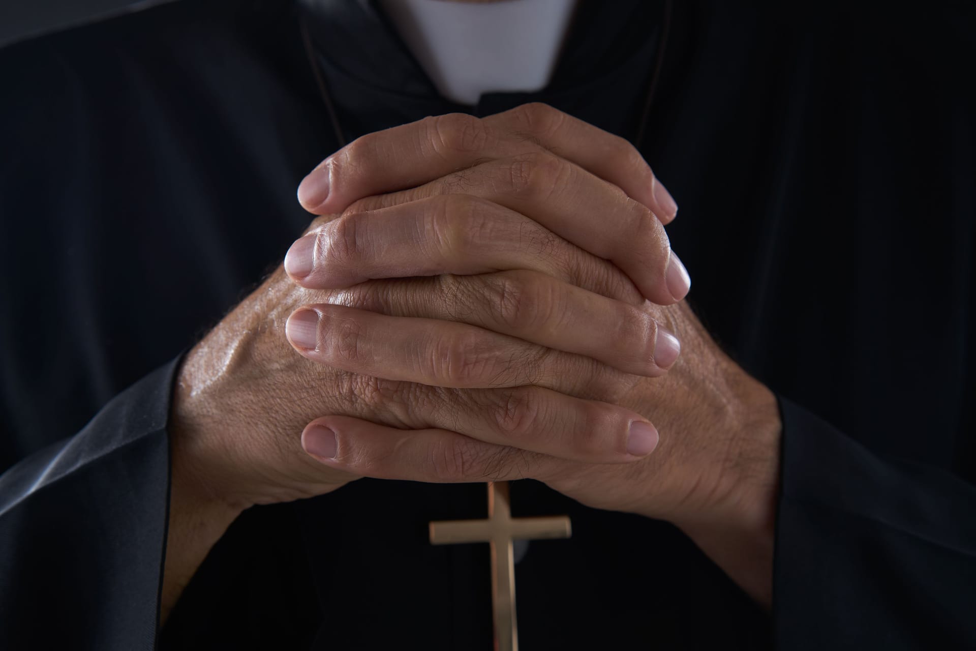 Praying hands priest portrait of male