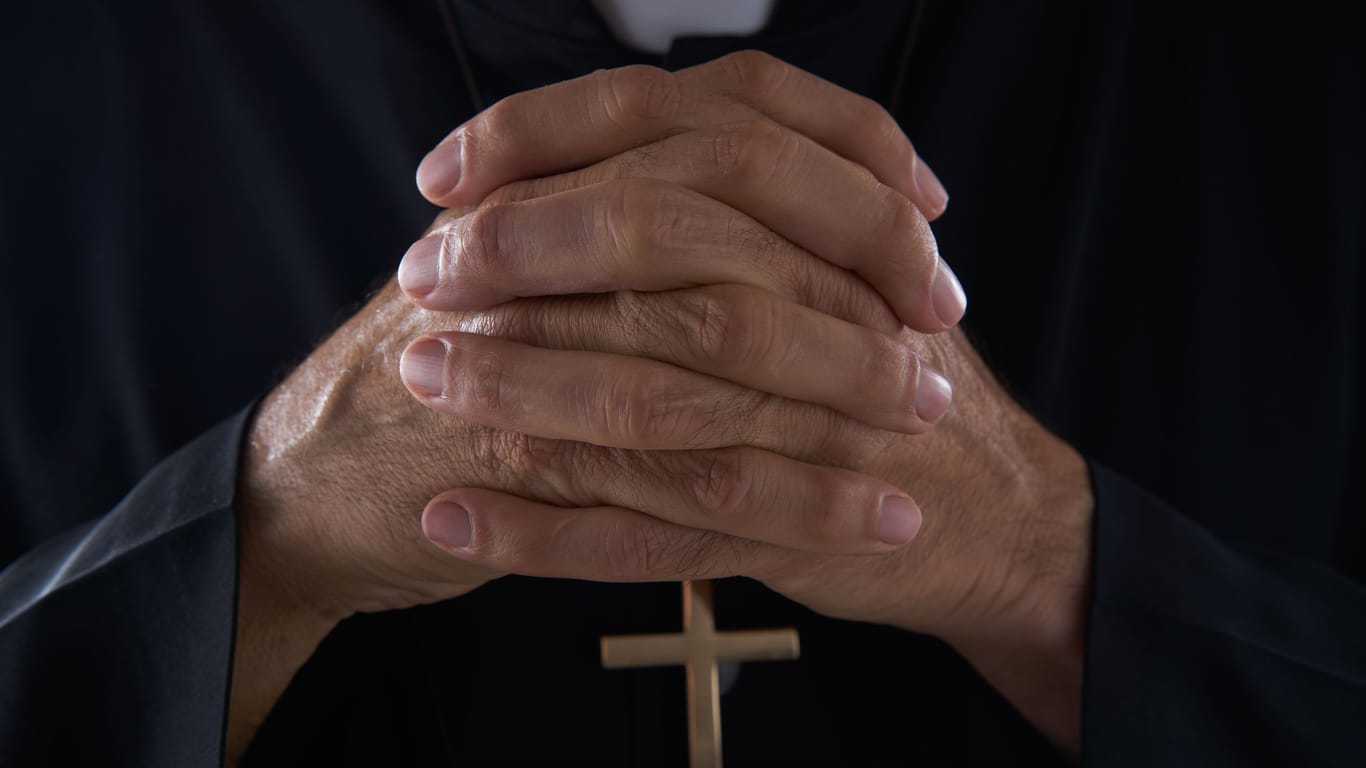 Praying hands priest portrait of male