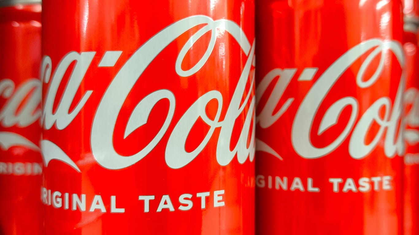 Arco, Italy - July 16, 2024: Coca Cola soft drink cans displayed on the shelf in a grocery supermarket in Italy **