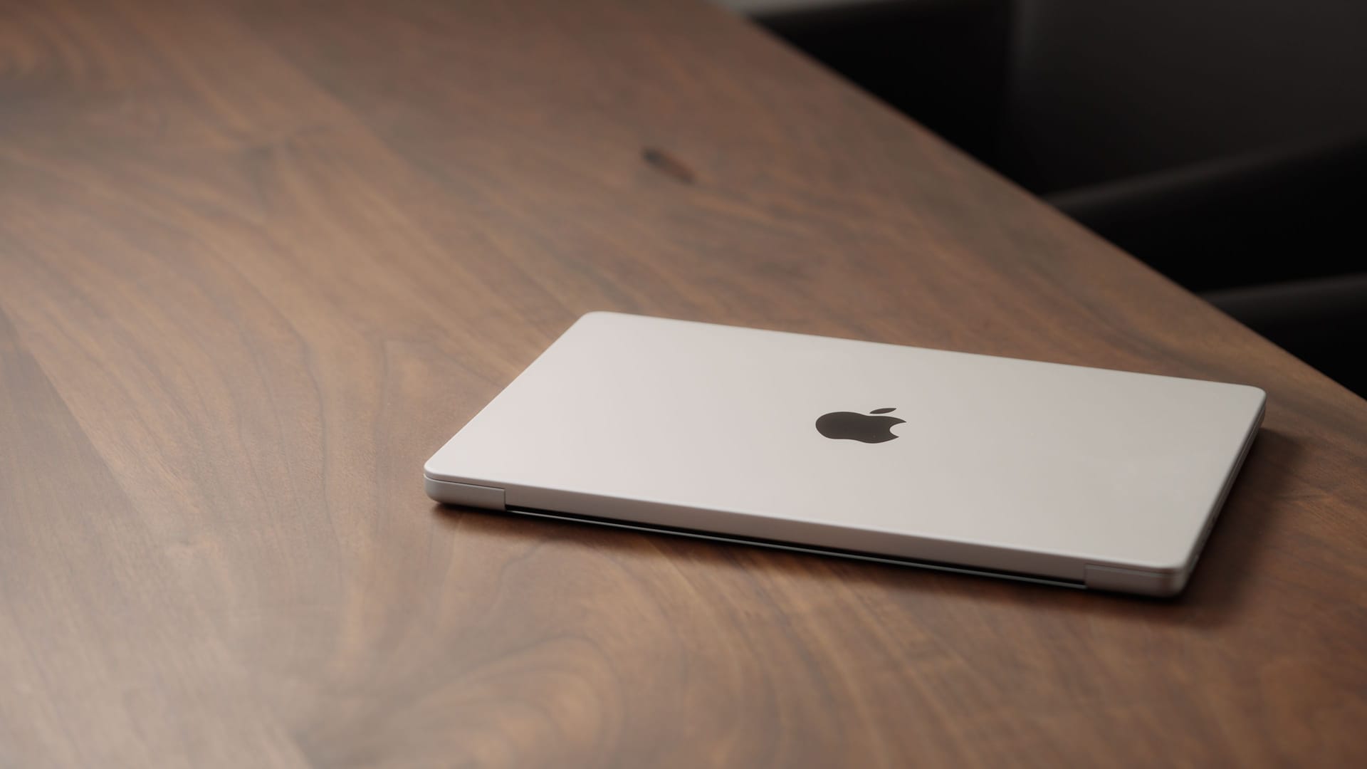 Saint-Petersburg, Russia - Circa December, 2022: CLoseup of the Macbook on walnut wood table with