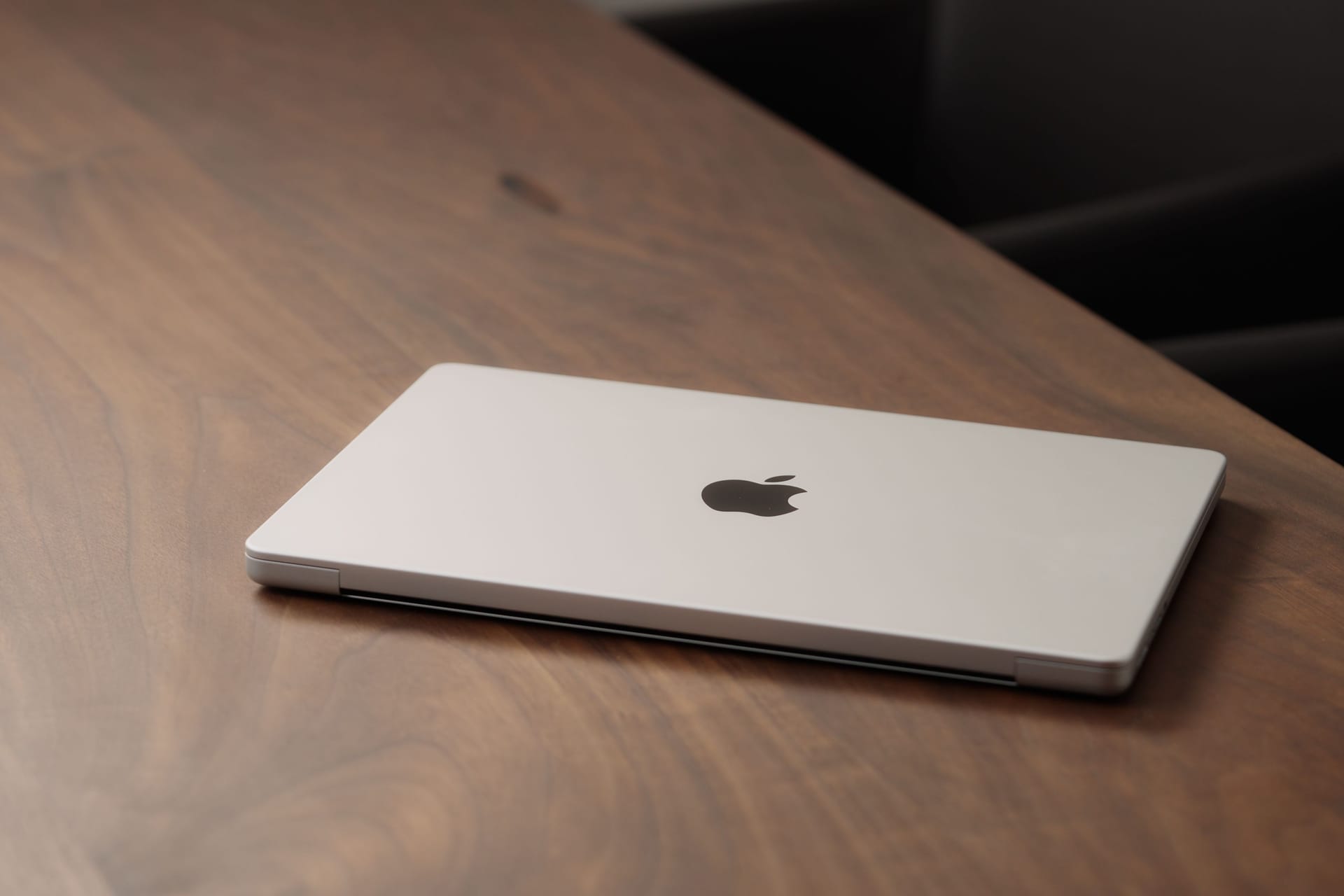 Saint-Petersburg, Russia - Circa December, 2022: CLoseup of the Macbook on walnut wood table with